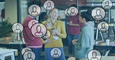 Young professionals networking and collaborating in modern open office with network overlay
