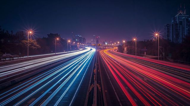 Highway light trails streaming into city nightscape with blue white and red neon streaks