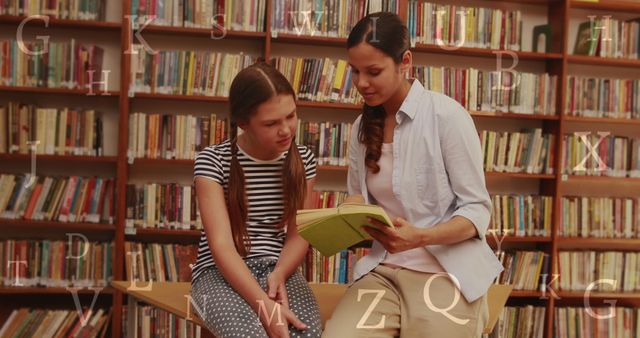 Female Teacher Reading Book to Student in Library - Download Free Stock Images Pikwizard.com