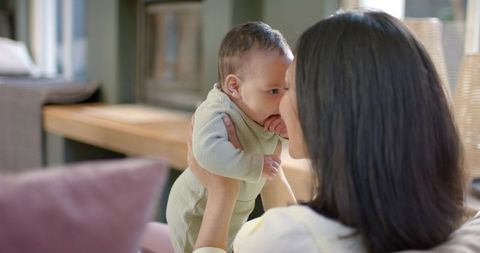 Mother Bonding with Infant Child in Cozy Living Room