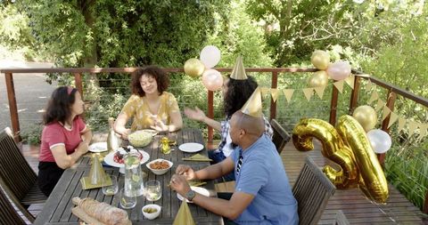 Diverse Friends Celebrating Birthday Party on Outdoor Terrace
