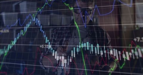 Financial analyst reviewing market charts in high-tech office