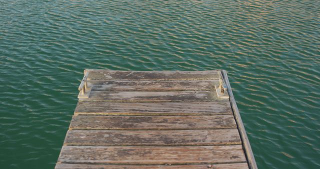 Wooden Dock Extending Over Tranquil Water Surface - Download Free Stock Images Pikwizard.com