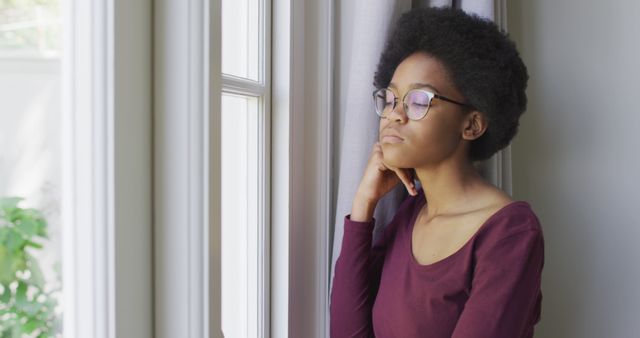 Thoughtful Afro Woman Wearing Glasses Gazing Through Window - Download Free Stock Images Pikwizard.com