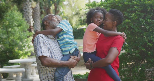 Happy Family with Grandparents Hugging Grandchildren in Park - Download Free Stock Images Pikwizard.com