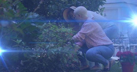 Couple tending garden together in tranquil backyard
