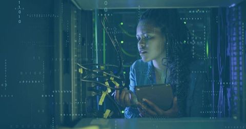 Network technician analyzing server connections in a data center