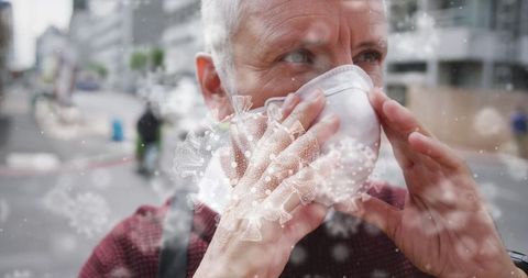 Senior Man Adjusting Mask on City Street With Virus Overlay