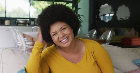 Joyful Plus Size Woman Relaxing at Home Smiling