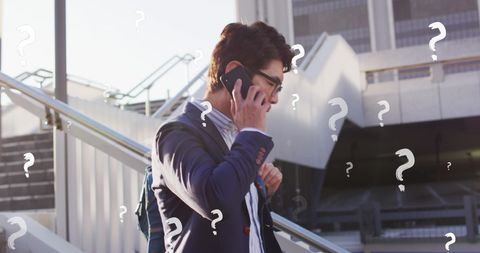 Confused businessman on phone with digital question marks