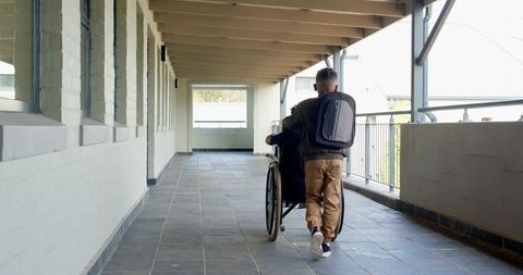 Diverse classmates helping in school corridor demonstrating accessibility