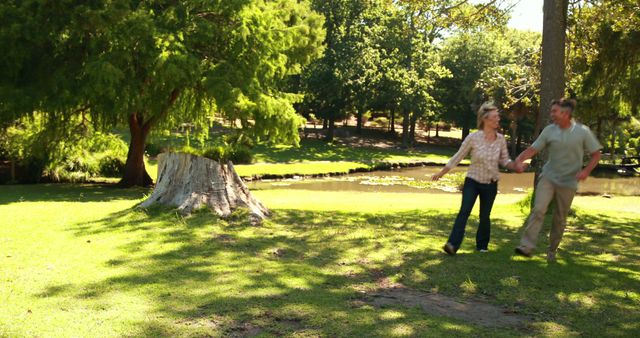 Senior Couple Enjoying a Walk in Sunny Park - Download Free Stock Images Pikwizard.com