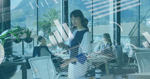 Businesswoman in Technology-Driven Office Analyzing Data