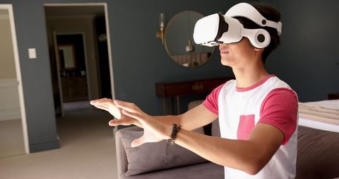 Asian Teen Enjoying Virtual Reality in Modern Living Room - Download Free Stock Images Pikwizard.com