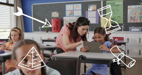 Asian teacher guiding student on tablet in diverse elementary classroom with recycling bin