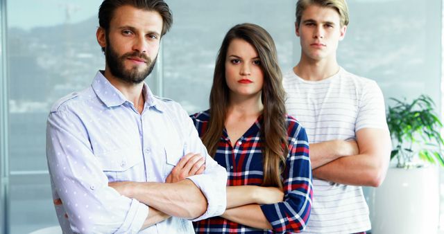 Confident Team Members Standing with Arms Crossed in Office - Download Free Stock Images Pikwizard.com