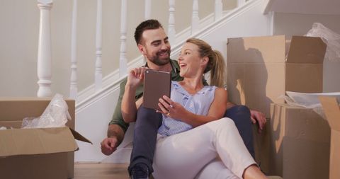 Happy Couple Enjoying New Home Amid Packing Boxes with Tablet - Download Free Stock Images Pikwizard.com