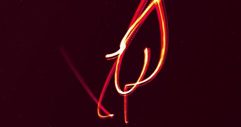 Glowing Red Light Trails in Motion on Black Background