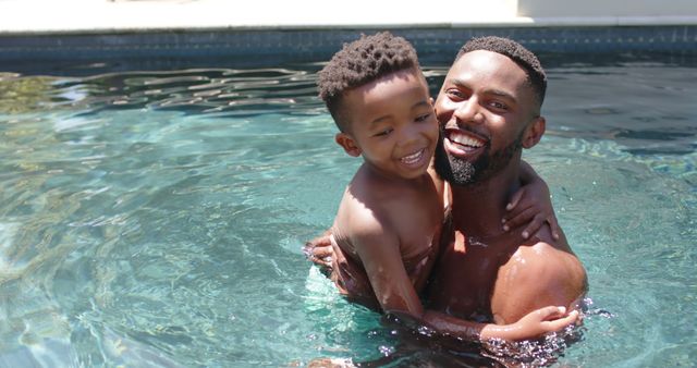 Happy Father and Son Embracing in Swimming Pool on Sunny Day - Download Free Stock Images Pikwizard.com