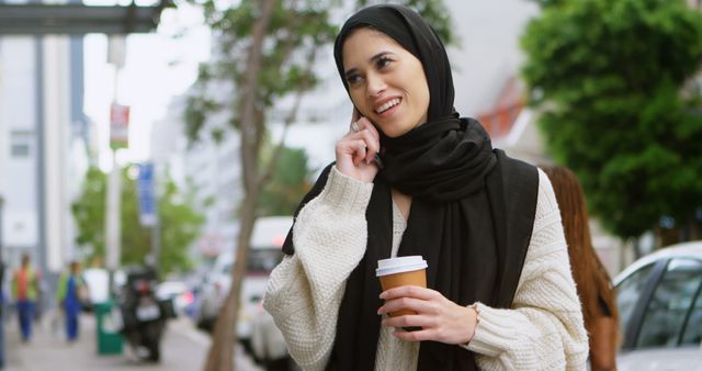 Smiling Woman in Hijab Talking on Mobile Phone Outdoors - Download Free Stock Images Pikwizard.com