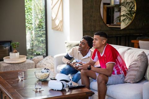 Diverse Friends Gaming Enjoying Relaxing Modern Technology Indoors