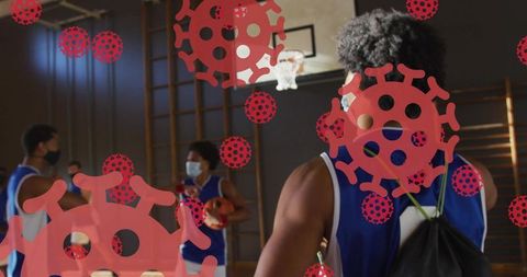 Youth basketball team practicing with face masks and covid-19 virus overlay in school gym