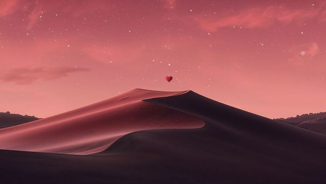 Surreal red desert dune at twilight with floating heart above crest, starry pink sky