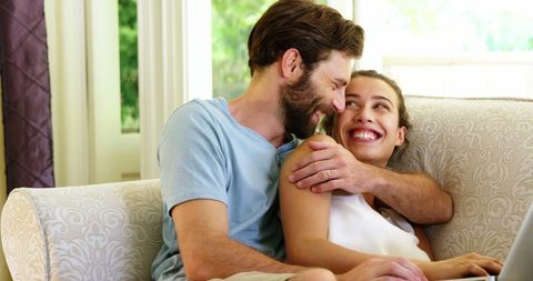 Happy Couple Embracing on Elegant Sofa at Home - Download Free Stock Images Pikwizard.com