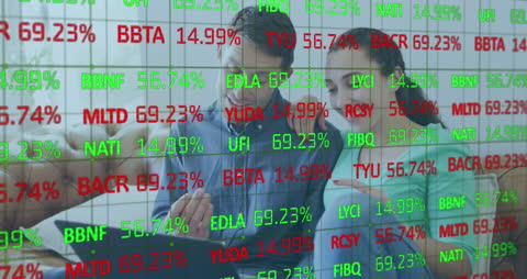 Couple Analyzing Stock Data with Laptop and Finance Projections