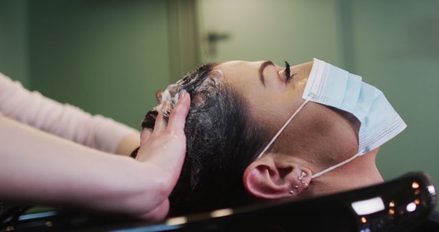 Woman with Face Mask Getting Hair Washed at Salon - Download Free Stock Images Pikwizard.com