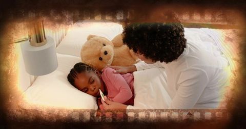 Mother checking daughter's temperature while comforting with teddy bear in cozy bedside