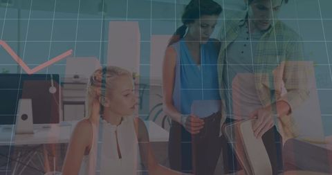 Young Professionals Analyzing Market Data Trends in Modern Office