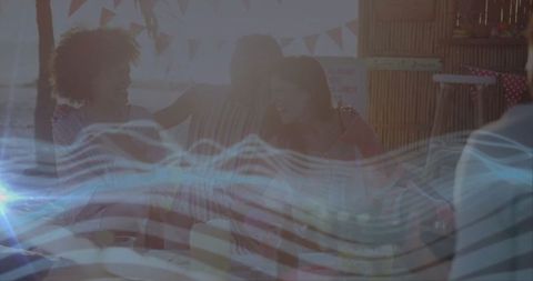 Friends Enjoying Tropical Beach Hut Picnic with Ocean View