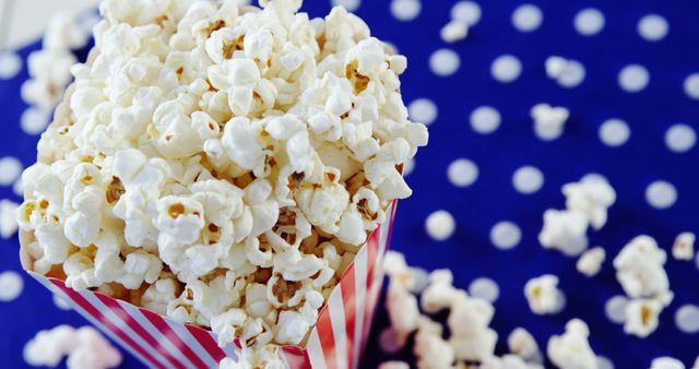 Perfect for illustrating concepts related to entertainment, movie theaters, and snacking. Could be used for marketing movie-related events, blog posts on snacks, themed parties, or advertisements for popcorn brands.