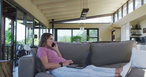 Pregnant Woman Relaxing on Sofa Having Phone Call