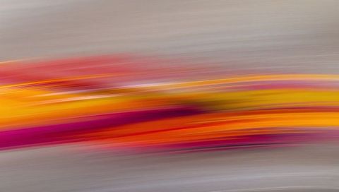 Flowing warm color streaks across muted gray-beige canvas for modern abstract background