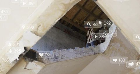 Man peering through ceiling hole in abandoned building surrounded by social media icons