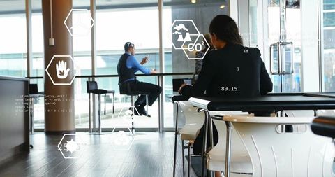 Business team collaborating in glass lounge reviewing co2 and interactive energy hud analytics