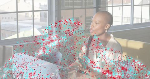 Talking businesswoman gesturing during creative collaboration in sunlit loft with large windows