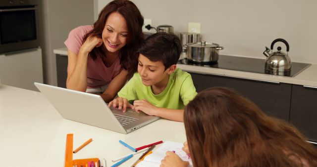 Mother Helping Children with Homework on Laptop in Kitchen - Download Free Stock Images Pikwizard.com