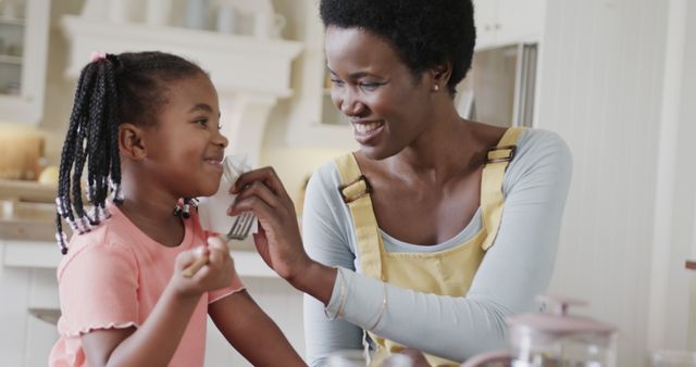 Mother and Daughter Bonding in Kitchen with Smiles and Laughter - Download Free Stock Images Pikwizard.com