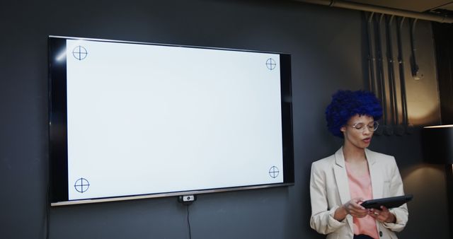 Biracial casual businesswoman making presentation using screen in office meeting room, copy space. Casual office, business, communication and work, unaltered.