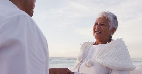 Senior Couple Sharing Romantic Moment on Beach at Sunset