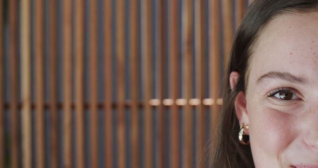 Close-Up Portrait of a Woman with Wooden Wall Background - Download Free Stock Images Pikwizard.com