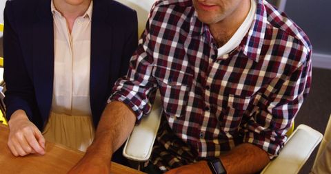 Business Executives Collaborating on Project in Office