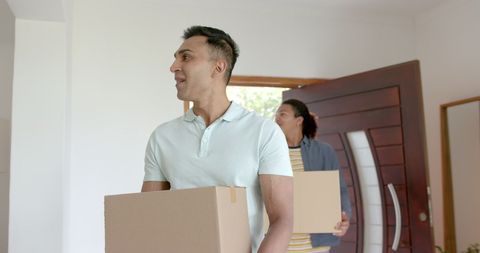 Happy Gay Couple Moving Into New Home with Boxes