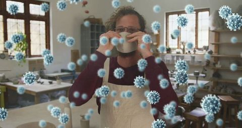 Man in Workshop Trying Face Mask During Pandemic