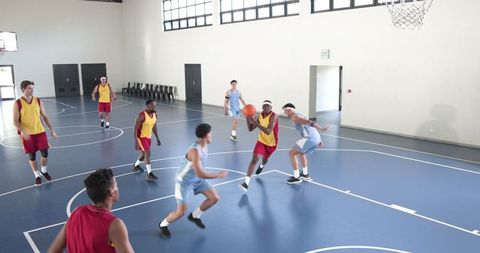 Intense Basketball Game in Indoor Gym with Diverse Players
