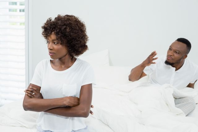 Couple arguing with each other in bedroom at home