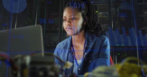 Female Engineer Analyzing Data Overlays in Server Room